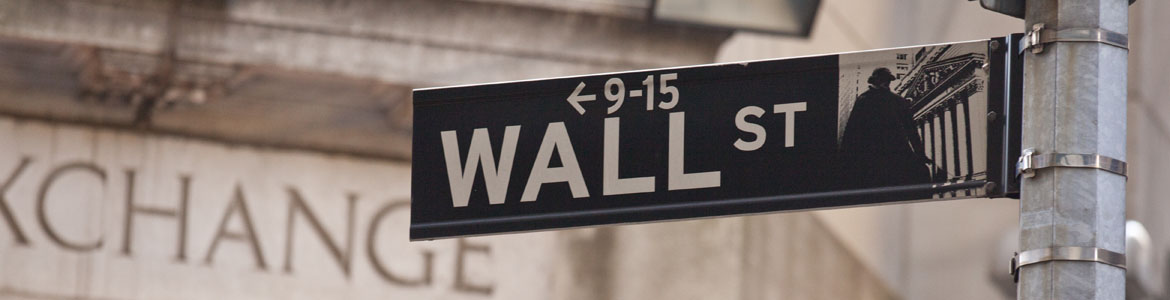 Wall Street sign with a building in background