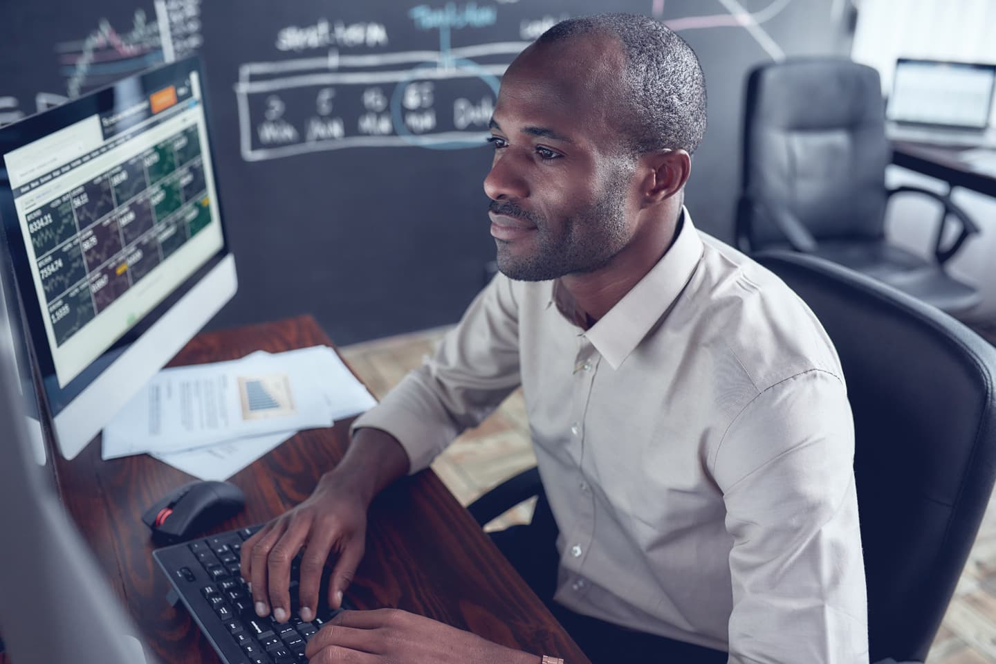 Un hombre mirando datos financieros en un monitor