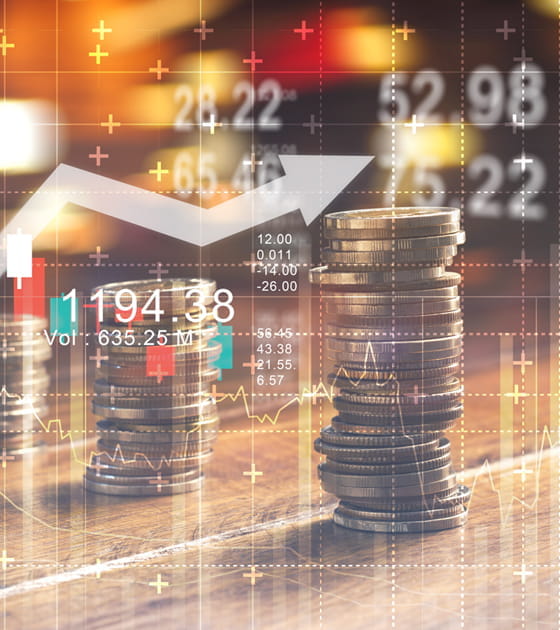 Monedas sobre una mesa con la imagen superpuesta de un gráfico
